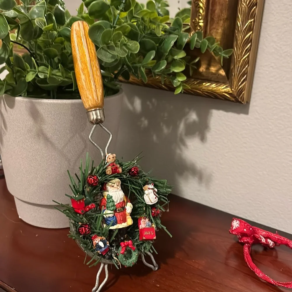 Handmade Santa Holiday Wreath on an old tea strainer.